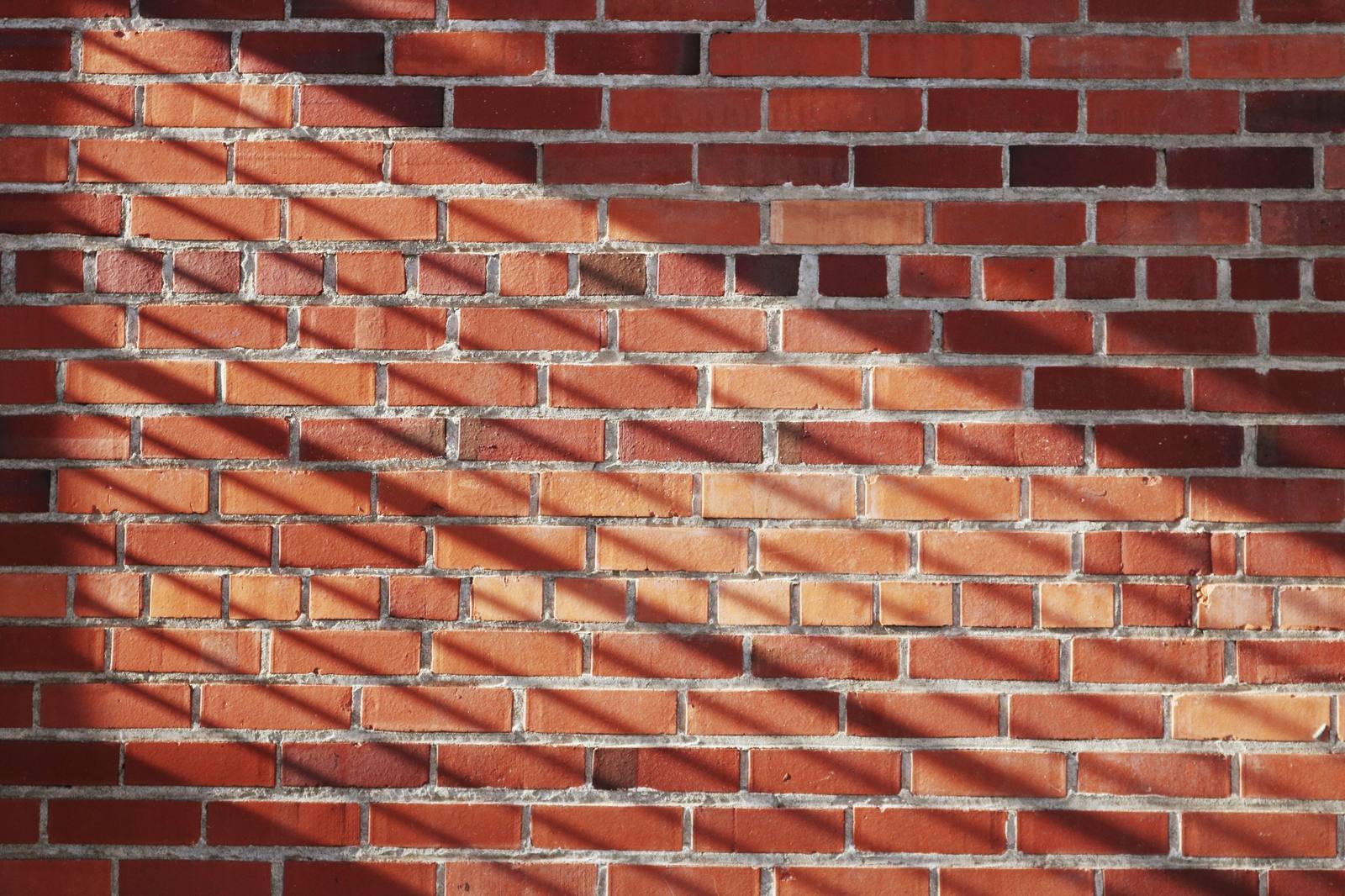 Mur de brique rouge éclairé par le soleil